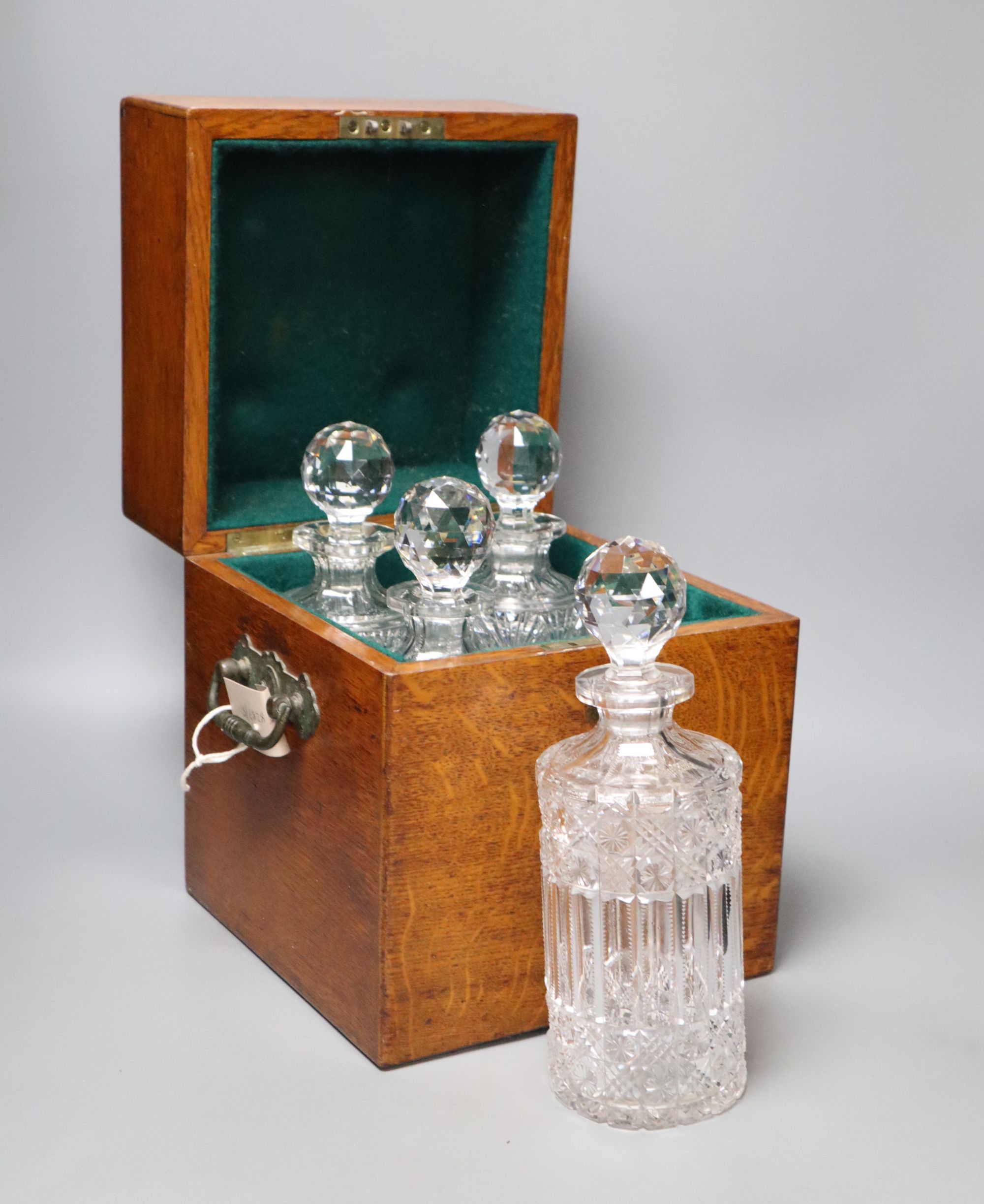 A Victorian oak four decanter box containing two pairs of cut glass decanters, overall height 30cm